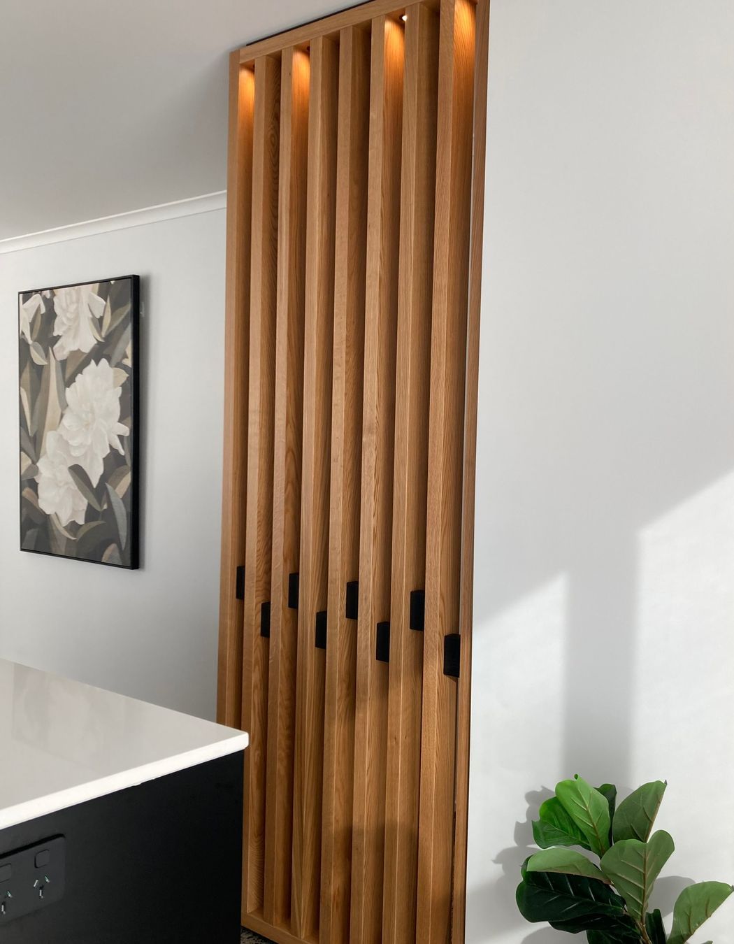 This American oak feature wall has been fitted with down lights to add an element of drama to the space.