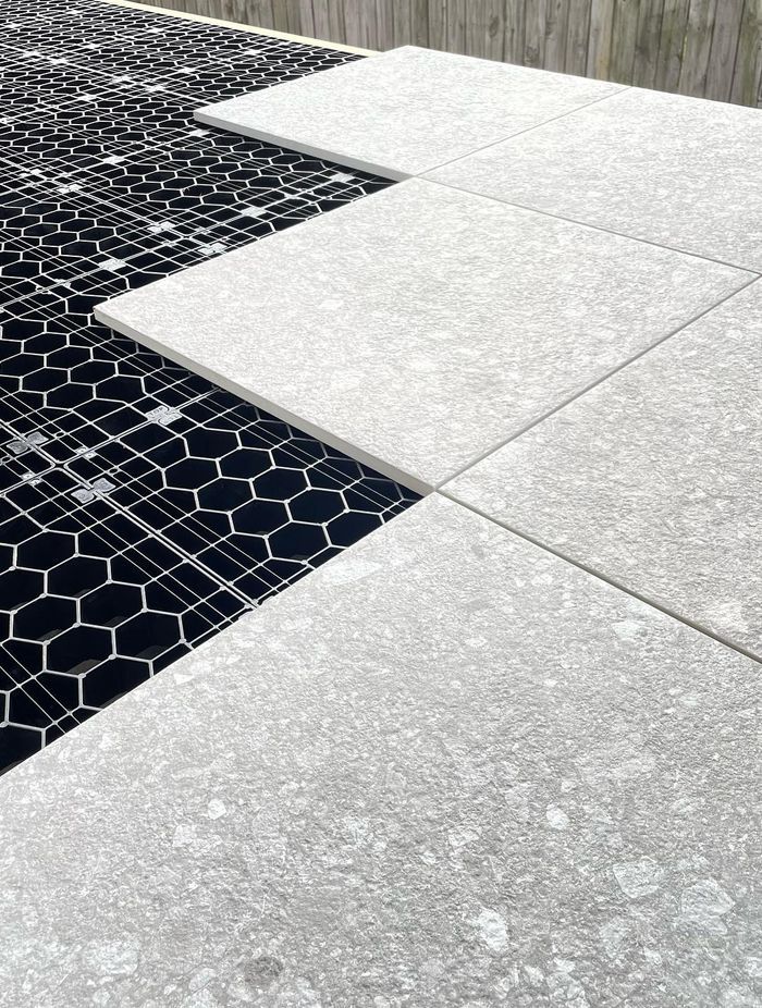 The load-bearing grates clip together to create a foundation for floating decks and tiled or paved landscaping areas.