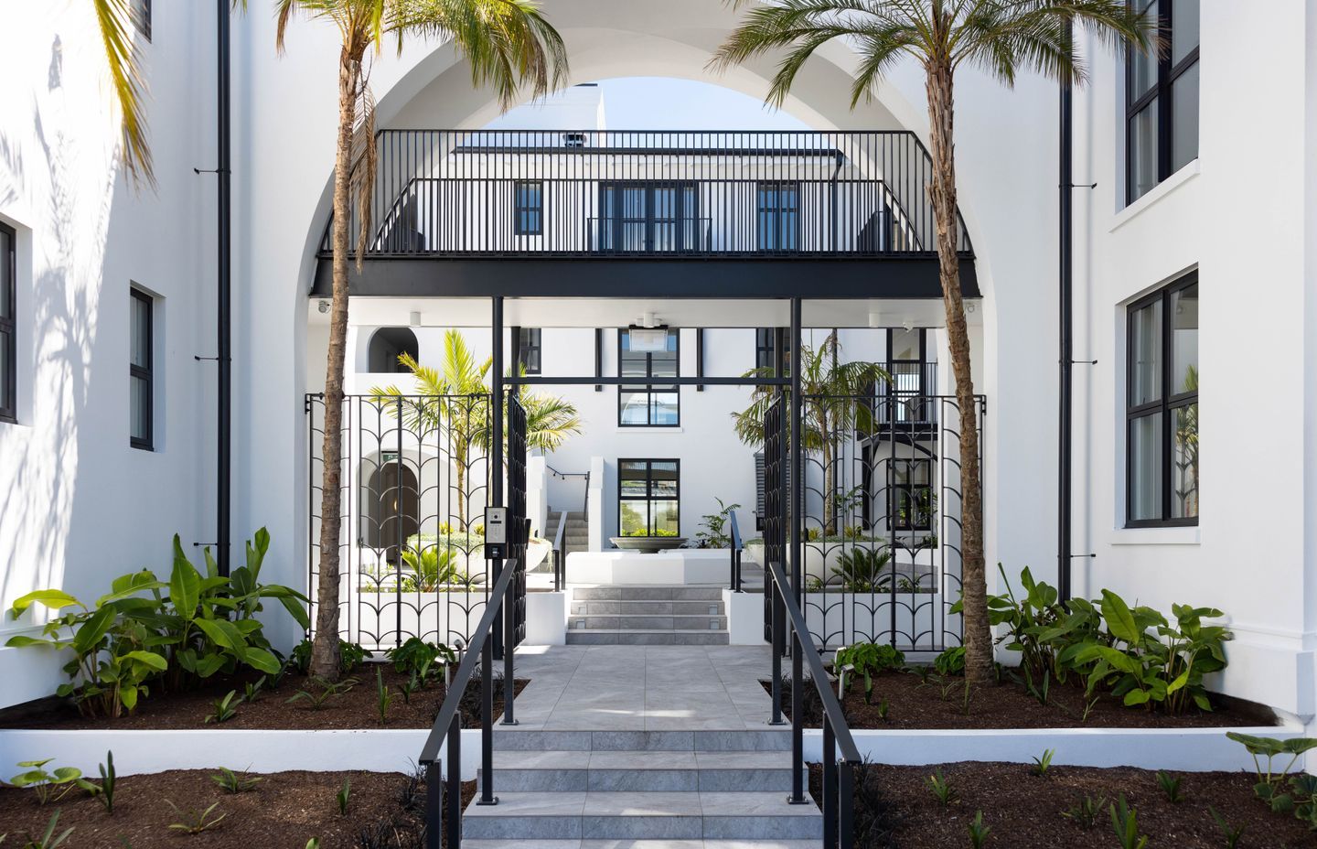 The entranceway of the Arches apartment complex from the street.