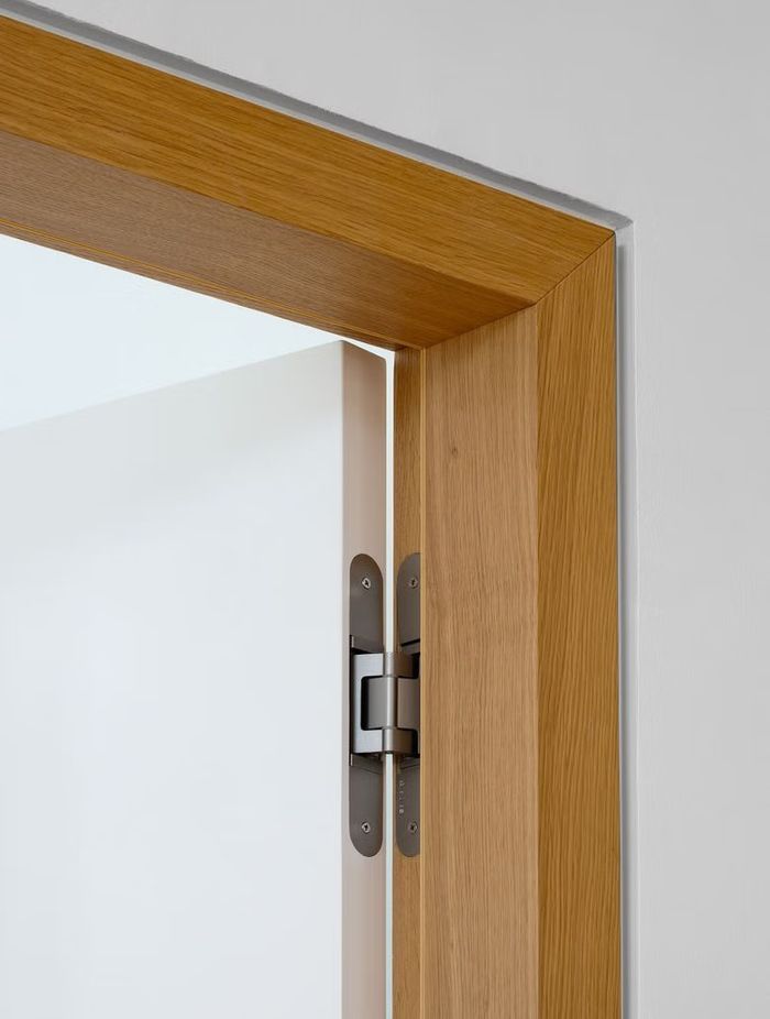 This TECTUS concealed hinge from Halliday + Baillie compliments the sleek aesthetic of the natural timber door frame