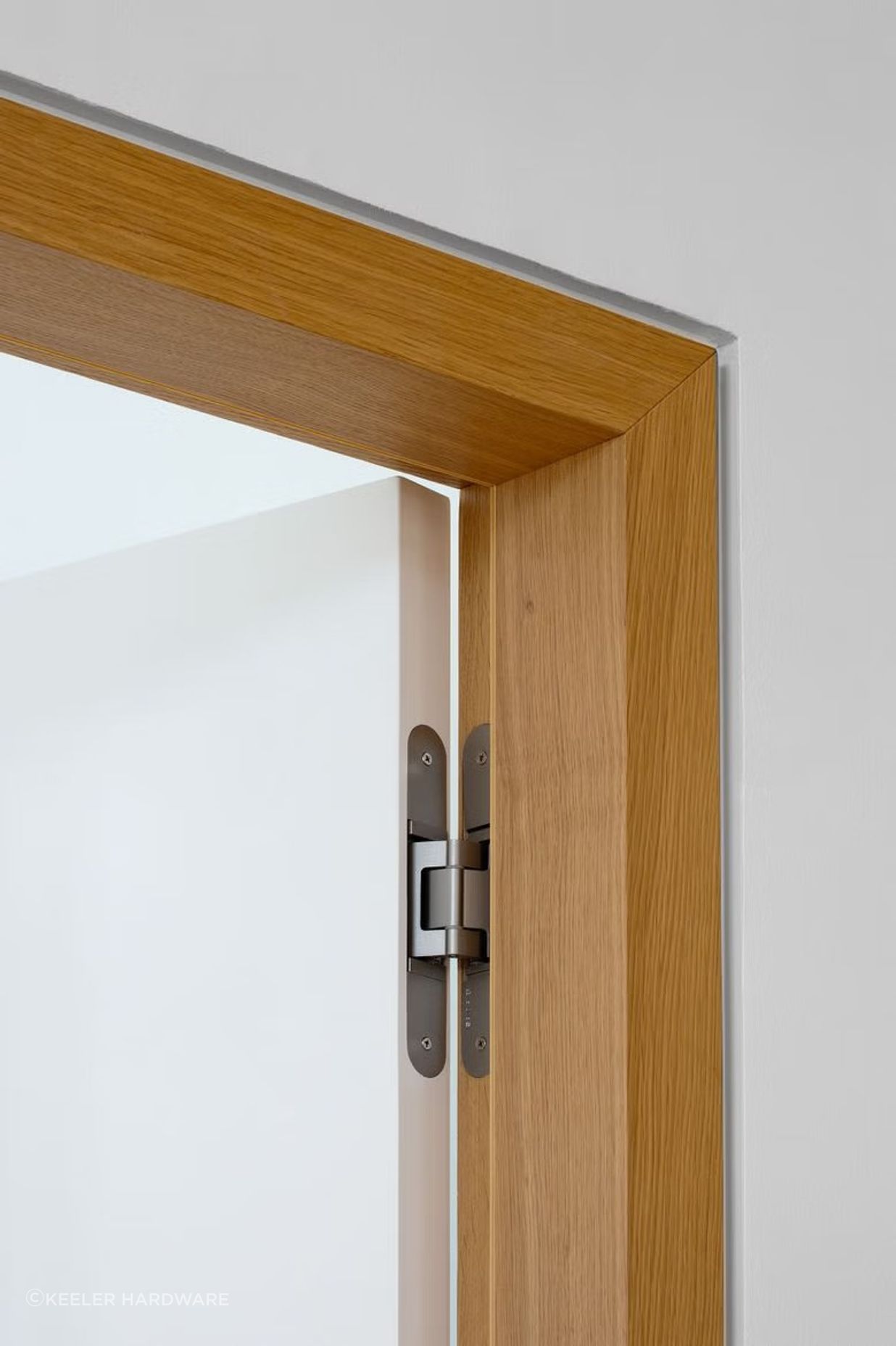 This TECTUS concealed hinge from Halliday + Baillie compliments the sleek aesthetic of the natural timber door frame