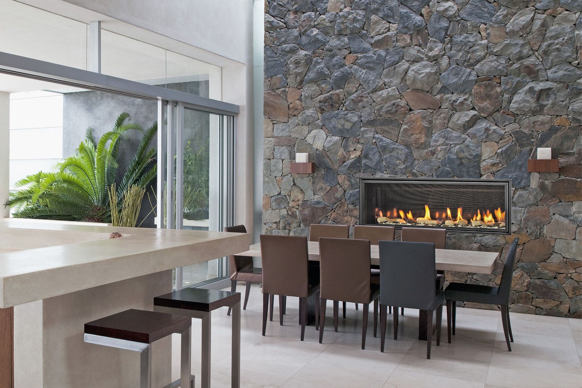 Flames spread across a bed of crushed glass, illuminated by LED underlighting, in the Mezzo fireplace.