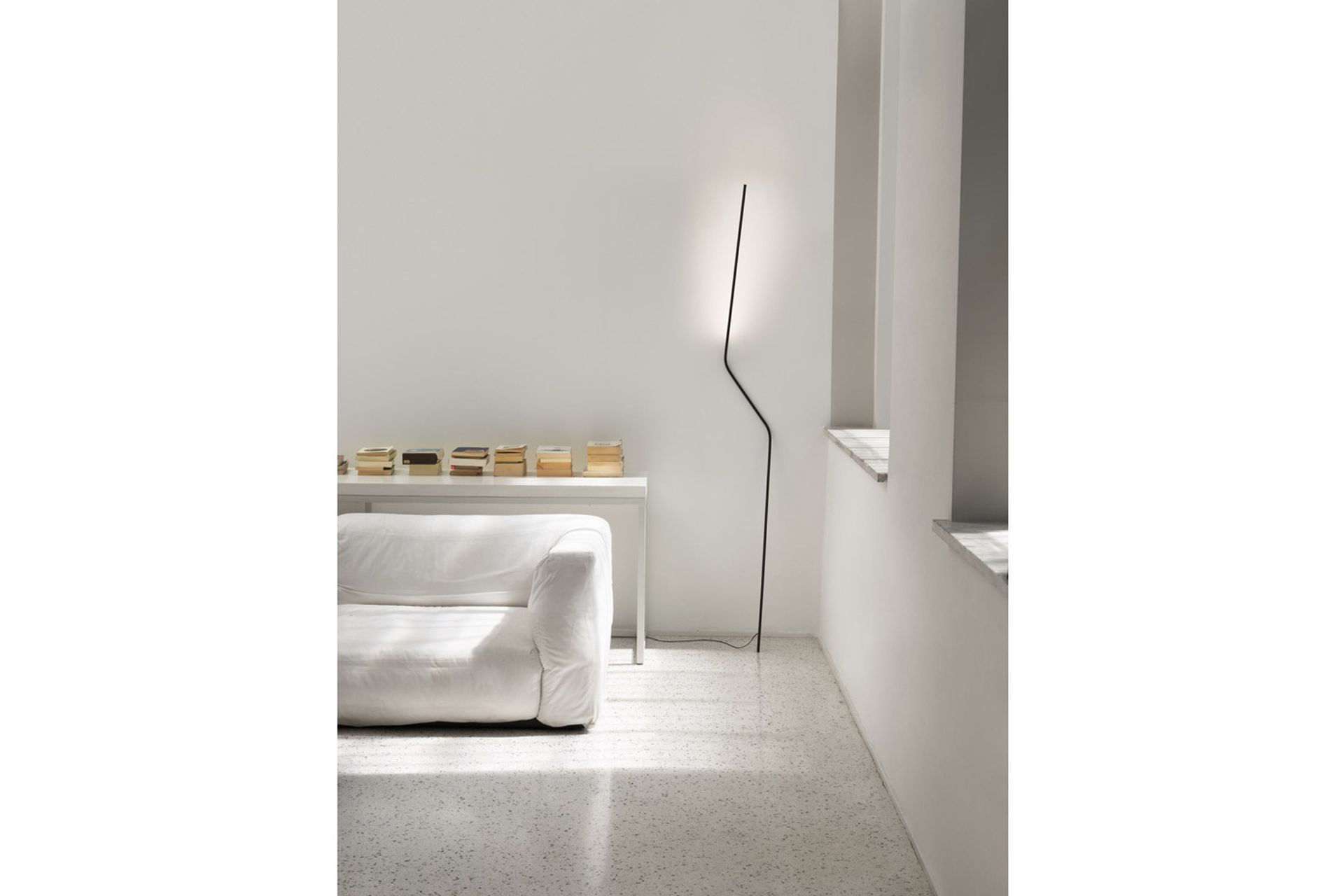 While it may look like it will topple over, the Neo Floor Lamp unique design ensures its stability.