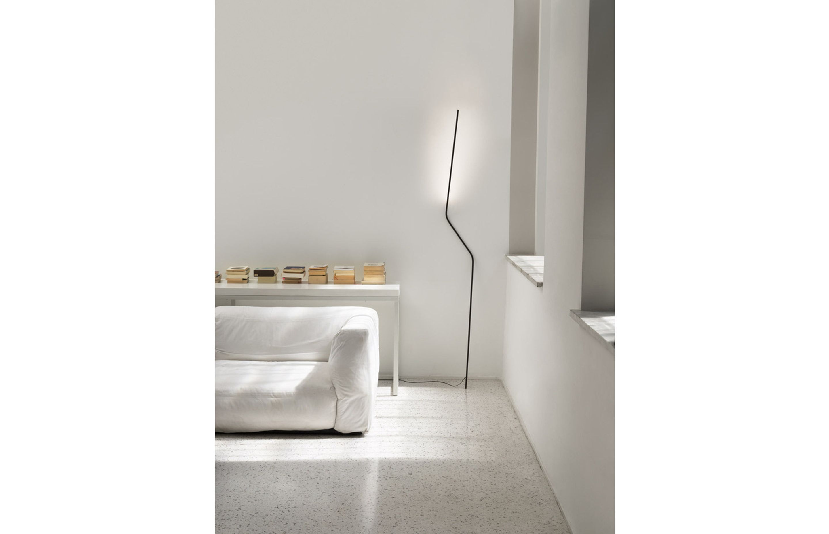 While it may look like it will topple over, the Neo Floor Lamp unique design ensures its stability.