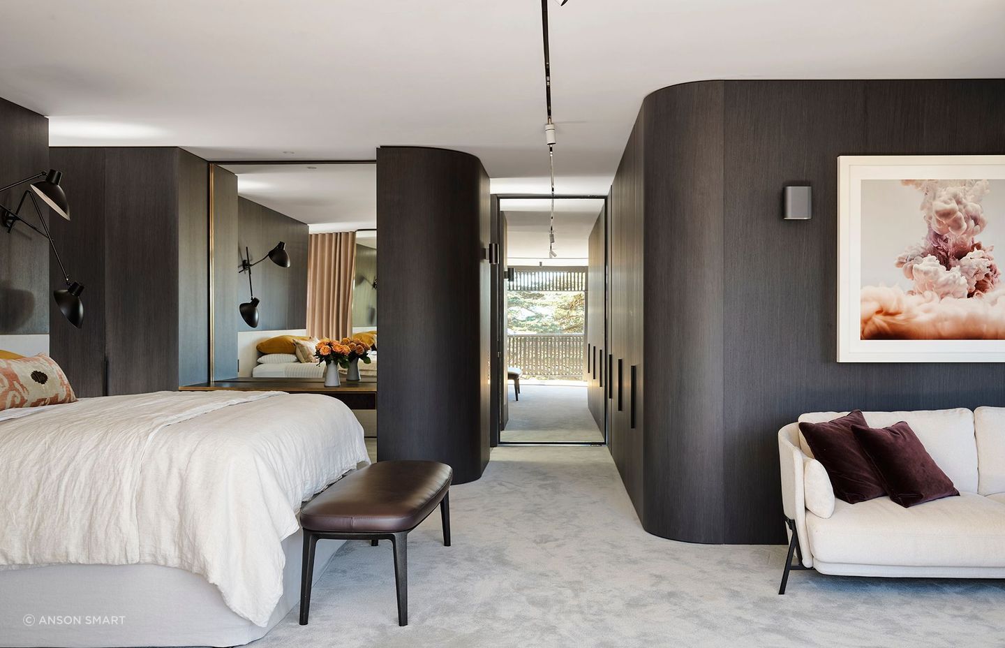 Curved walls soften the main bedroom suite featuring Joseph Giles architectural hardware throughout.