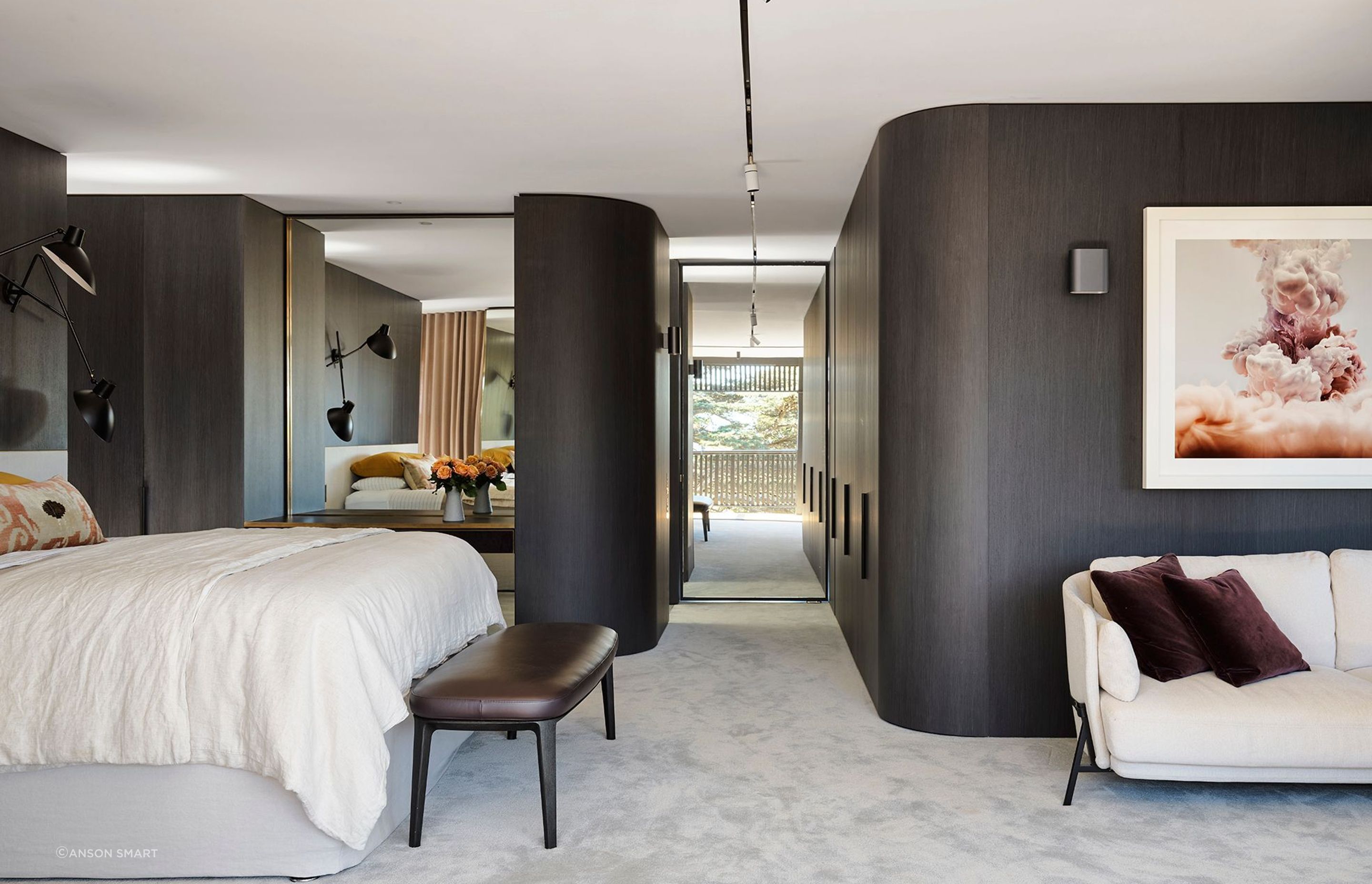 Curved walls soften the main bedroom suite featuring Joseph Giles architectural hardware throughout.