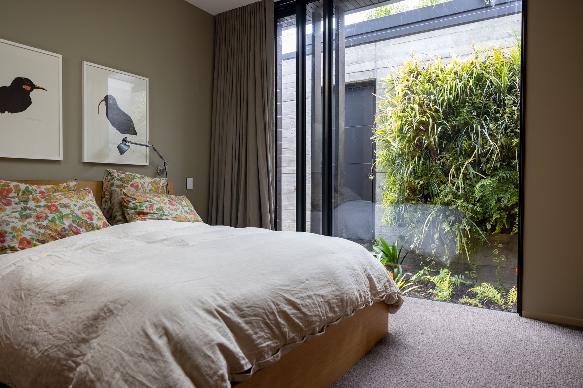 Hidden between the garage and the house, this green wall installed by Natural Habitats can be enjoyed through the bedroom's full-height window – bringing the outdoors in.