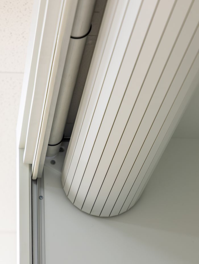When it is retracted, the roller door is neatly concealed inside the cupboard.