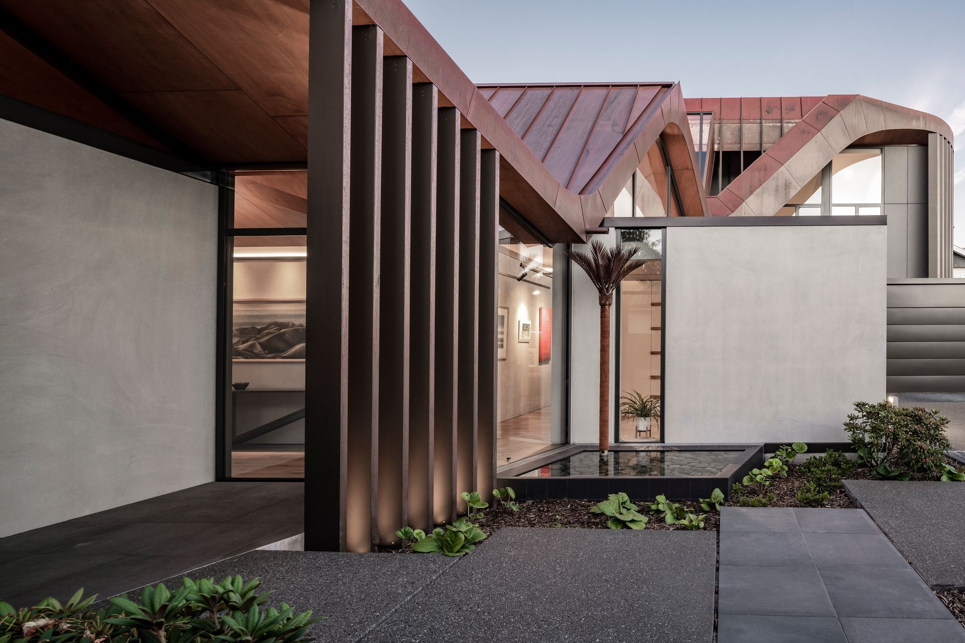 The 651 oxide colours the standard aggregate concrete to a soothing pale grey in the spectacular Concrete Copper house in Christchurch.