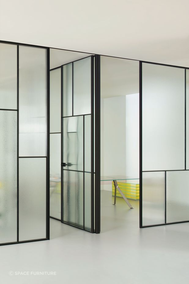 The Glas Italia Sherazade Wall Patchwork is a floor-to-ceiling partition wall made by juxtaposing and fixing panels divided into four squares through a click system, featuring different types of monolithic tempered glass.