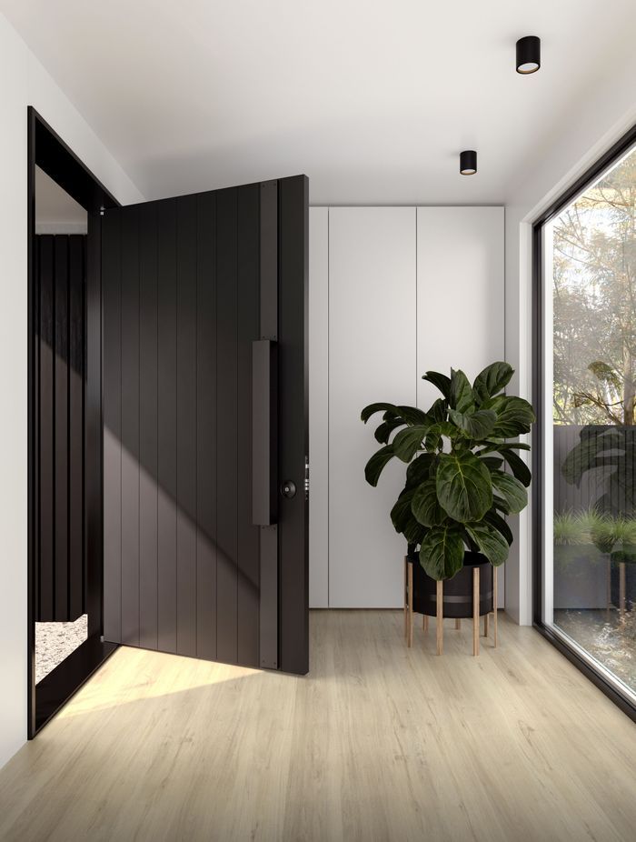 The dark colour of this aluminium door blends seamlessly with the contemporary door hardware.