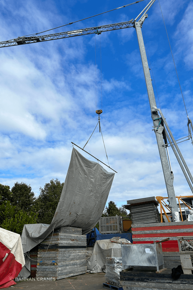 The crane can cover site areas with tarps to keep an area or material dry.