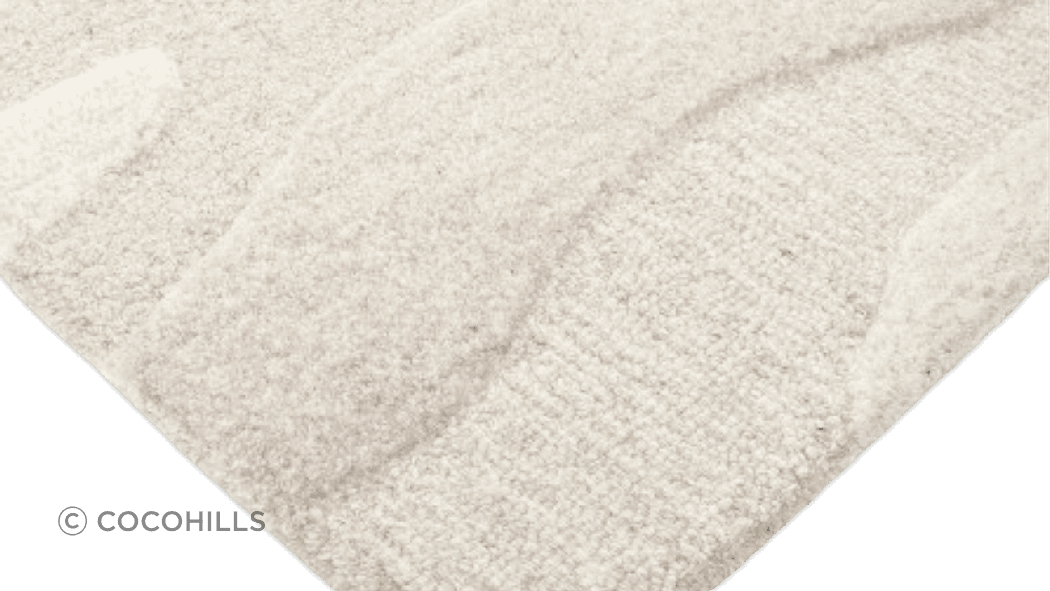 Handtufted from 100% wool, the undulating design of the Shoreline rug is achieved through sections of cut and looped pile, resulting in a captivating visual piece.
