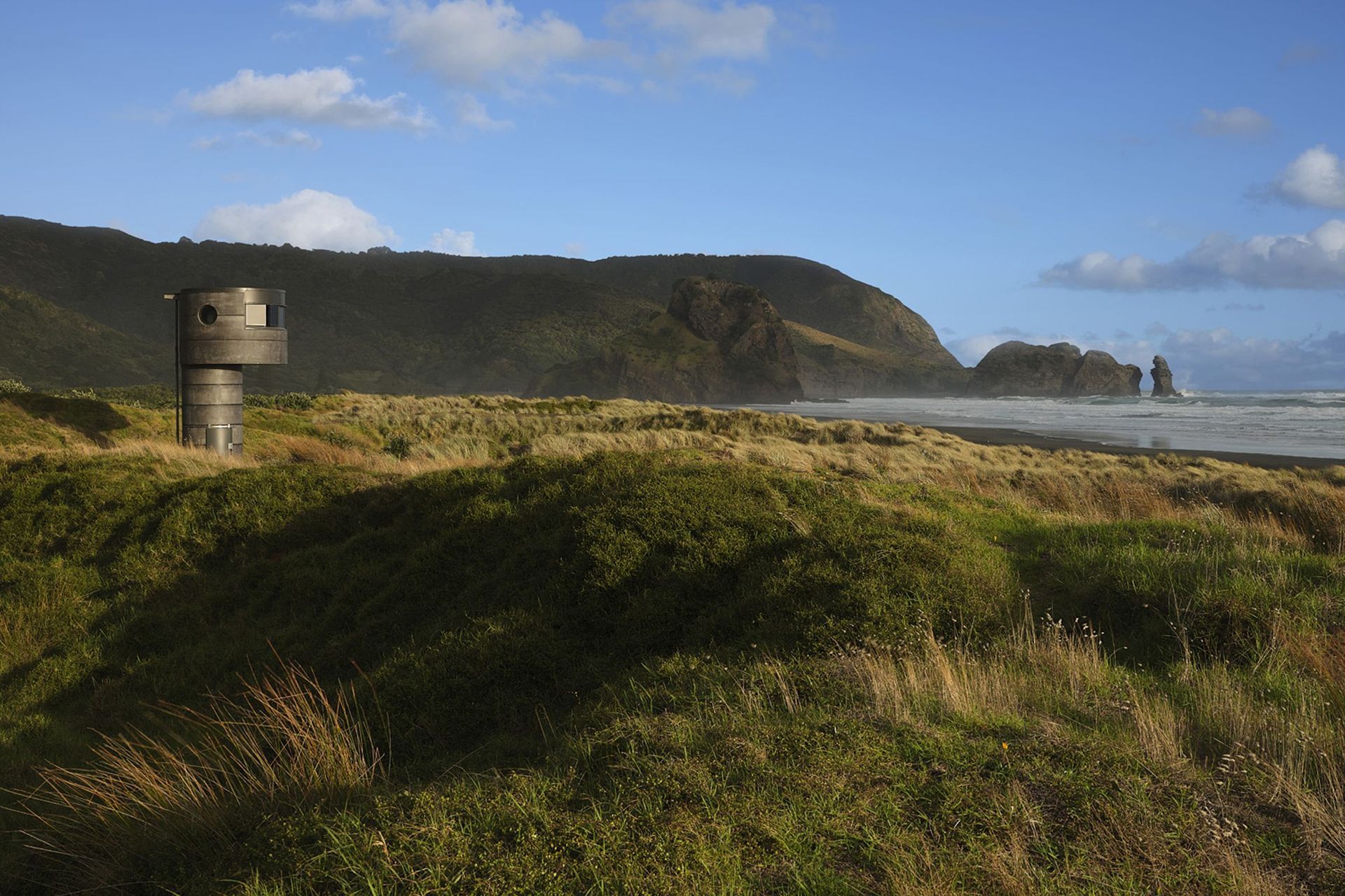 From a distance, Te Pae appears to belong to North Piha’s rugged landscape.