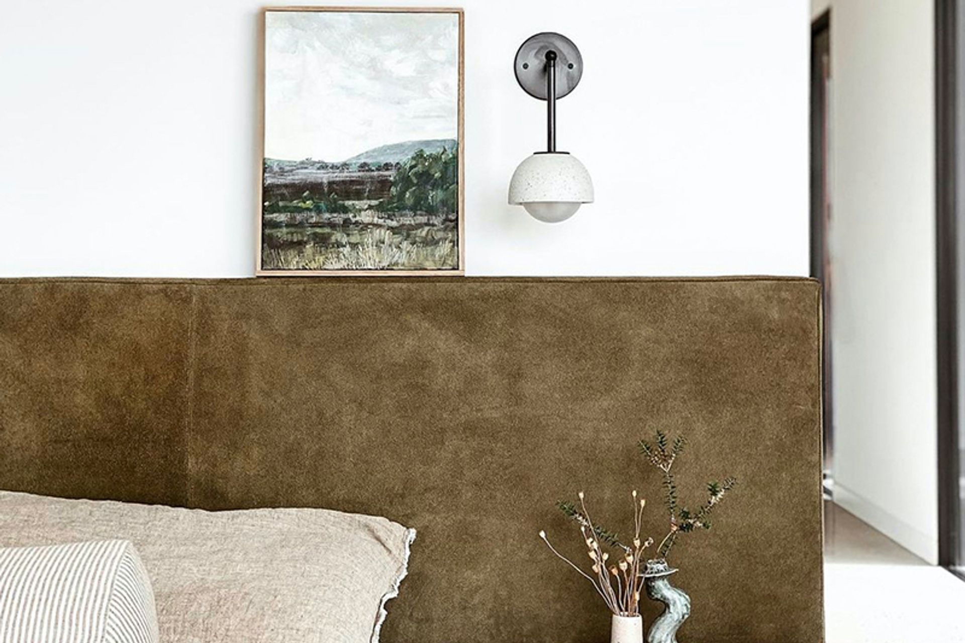 Options like the Terra 0 Long Articulating Wall Light show how wall lighting can work with art and ornamental pieces