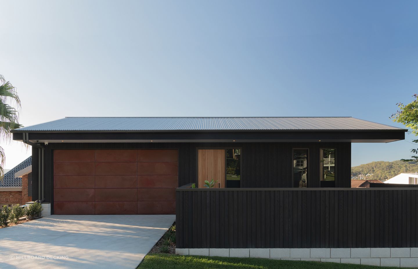 Millboard's Envello cladding in Burnt Cedar.