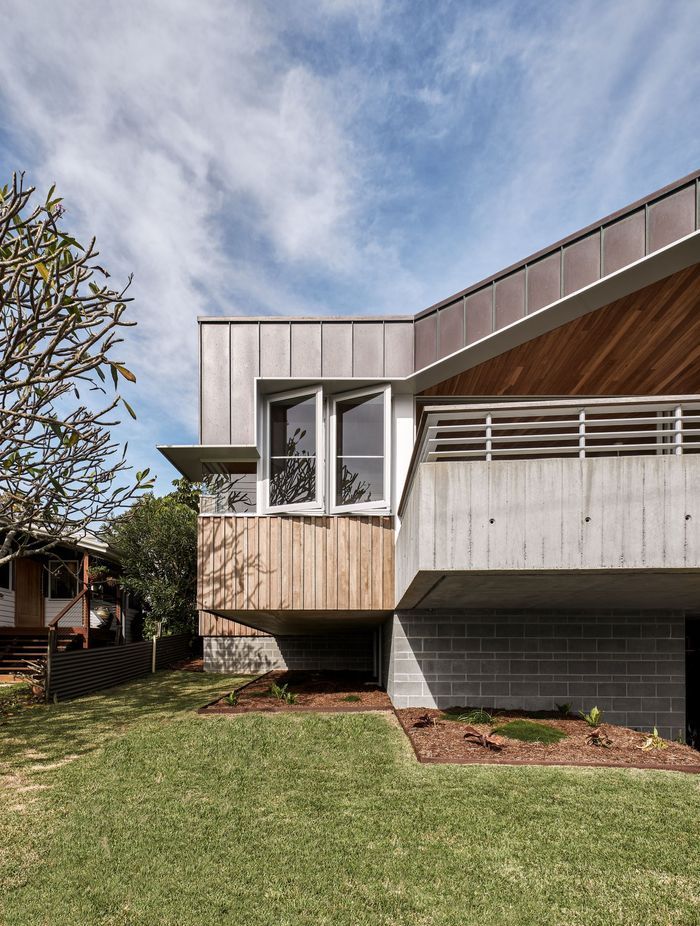 The hood on this beach house runs the length of this home for both practical and aesthetic purposes.
