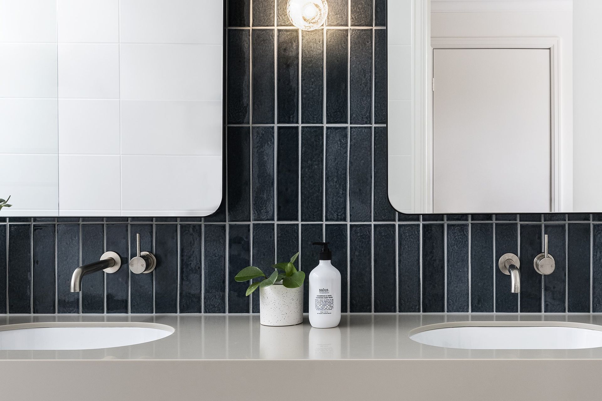 An elegant use of Motto Dark Blue Subway Tiles, vertically orientated for style
