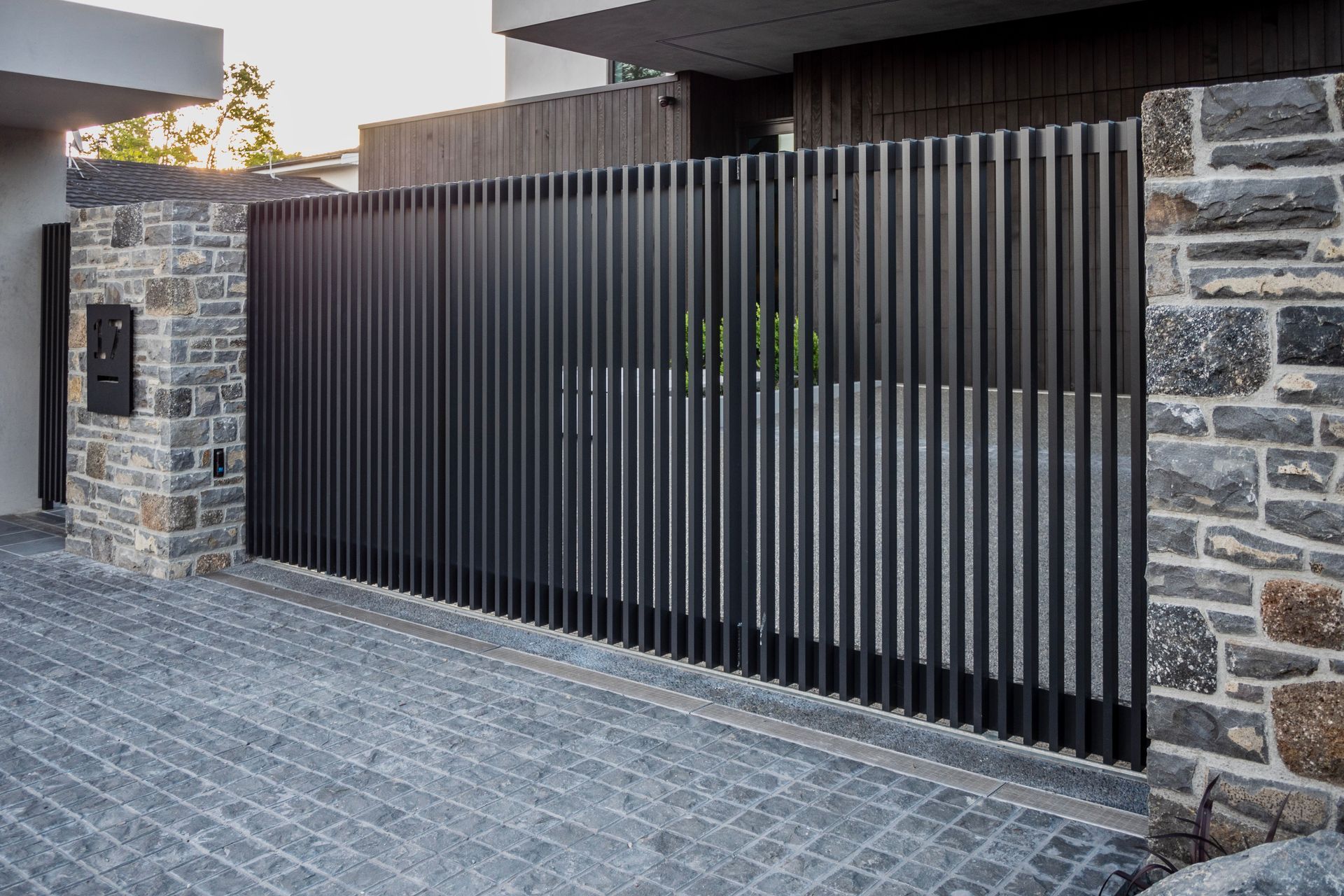 The gate, which utilises an automatic sliding drive mechanism, is equipped with safety beams.