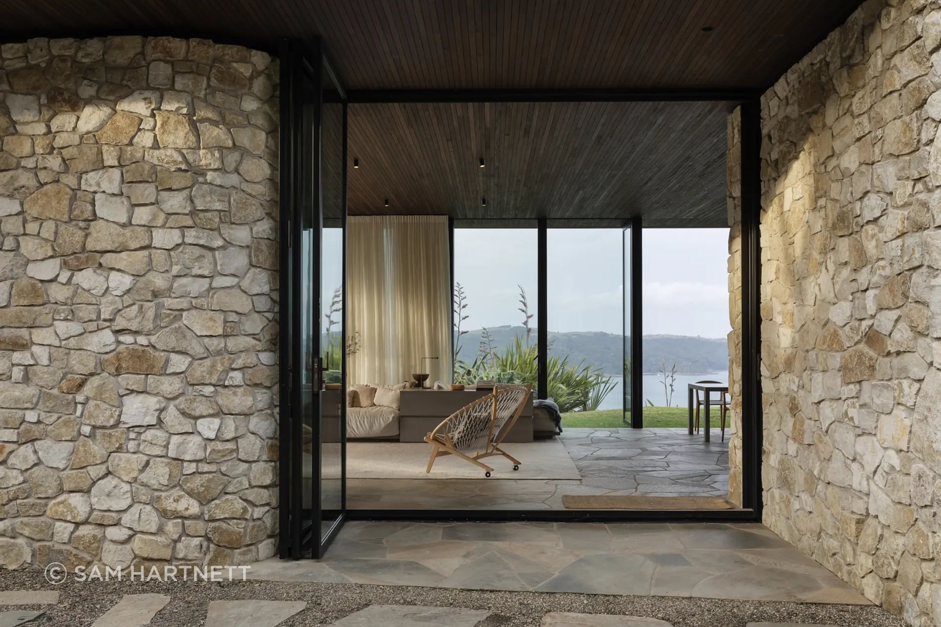 The Aria limestone continues through thresholds and exterior walls, showing how early material specification can shape the way a home is experienced from arrival through to interior space.