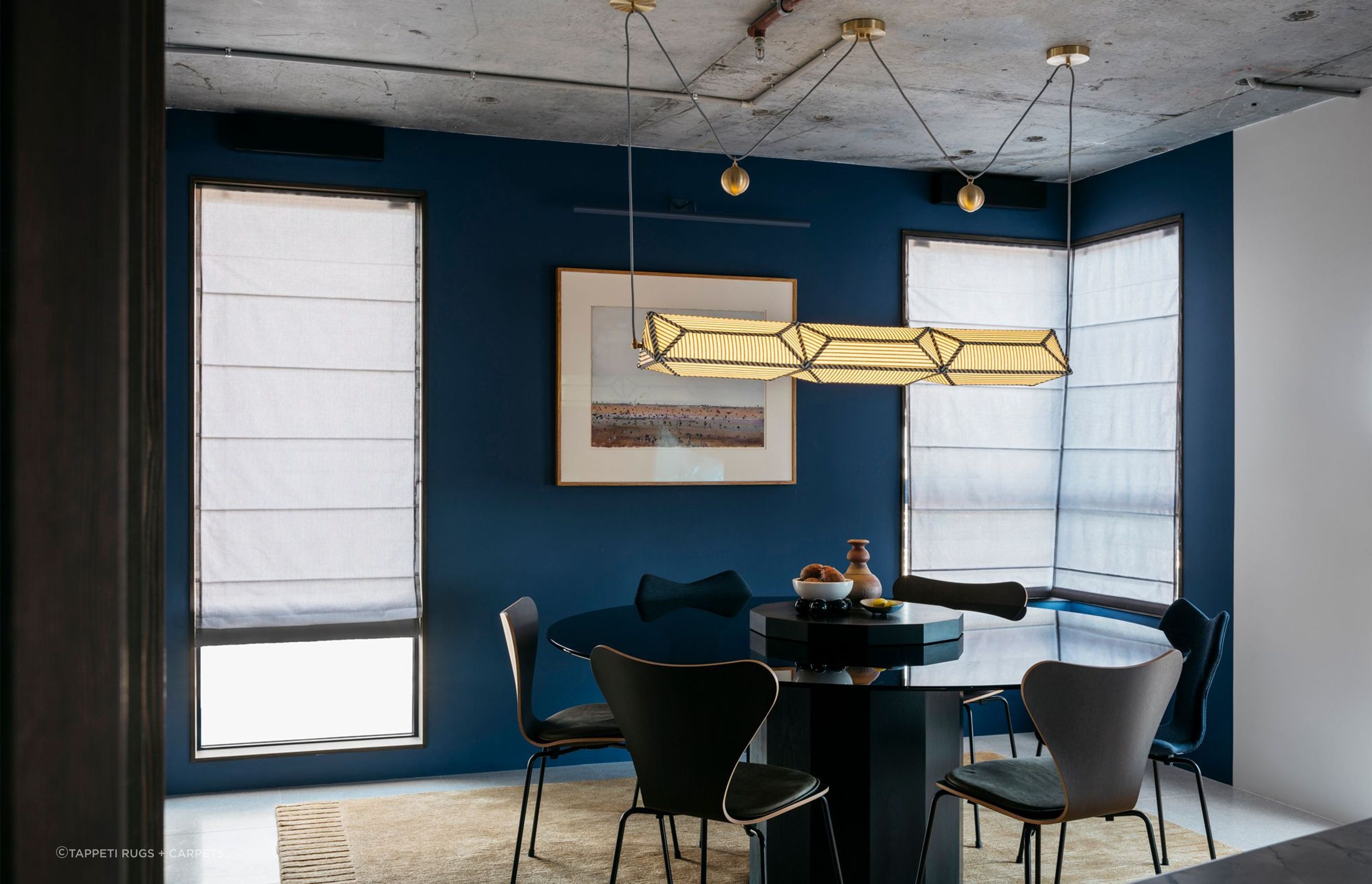 Bold wall colours and a featured rug highlight the 1906 Apartment