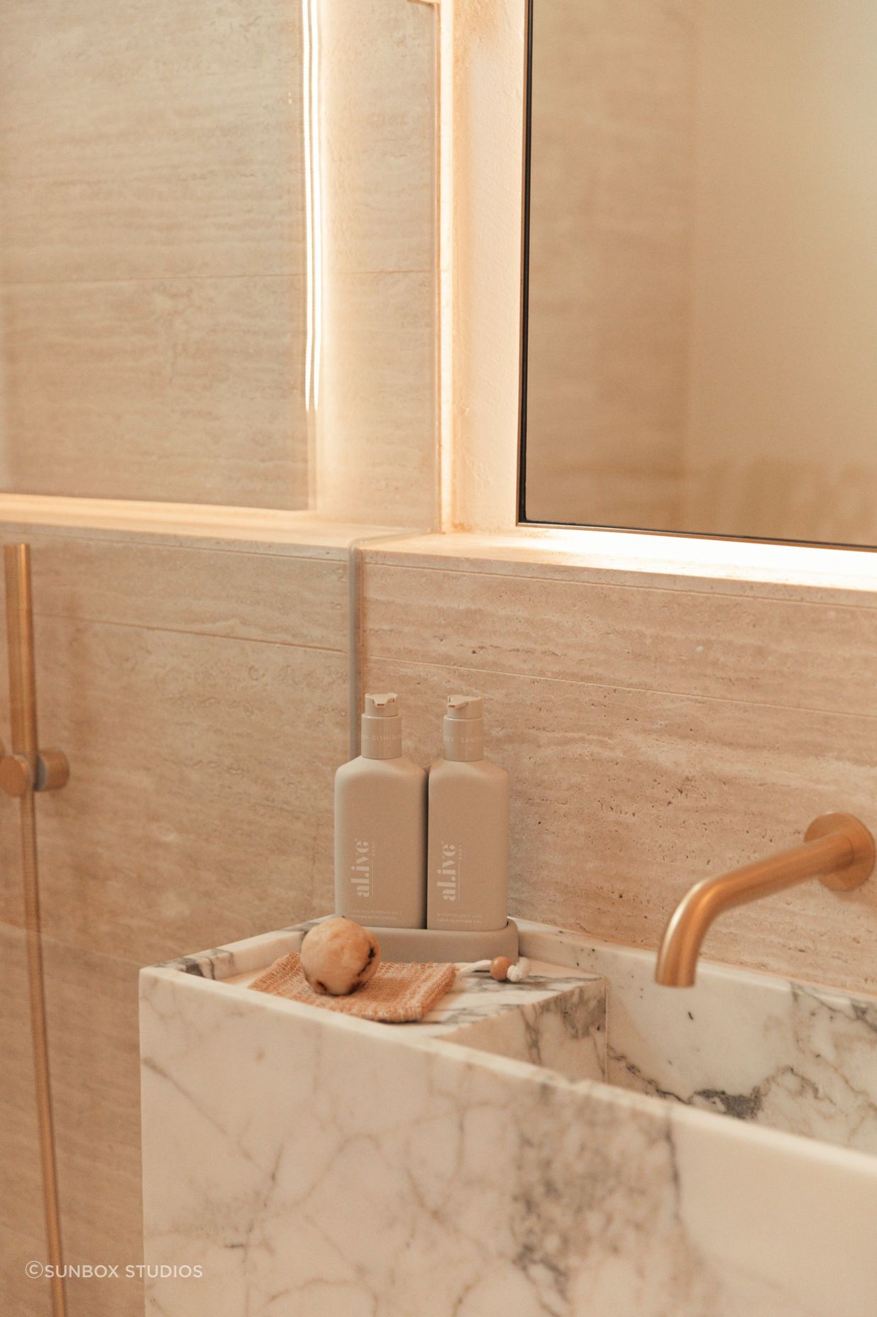 In the bathroom, a bespoke stone basin is the ultimate in luxury.