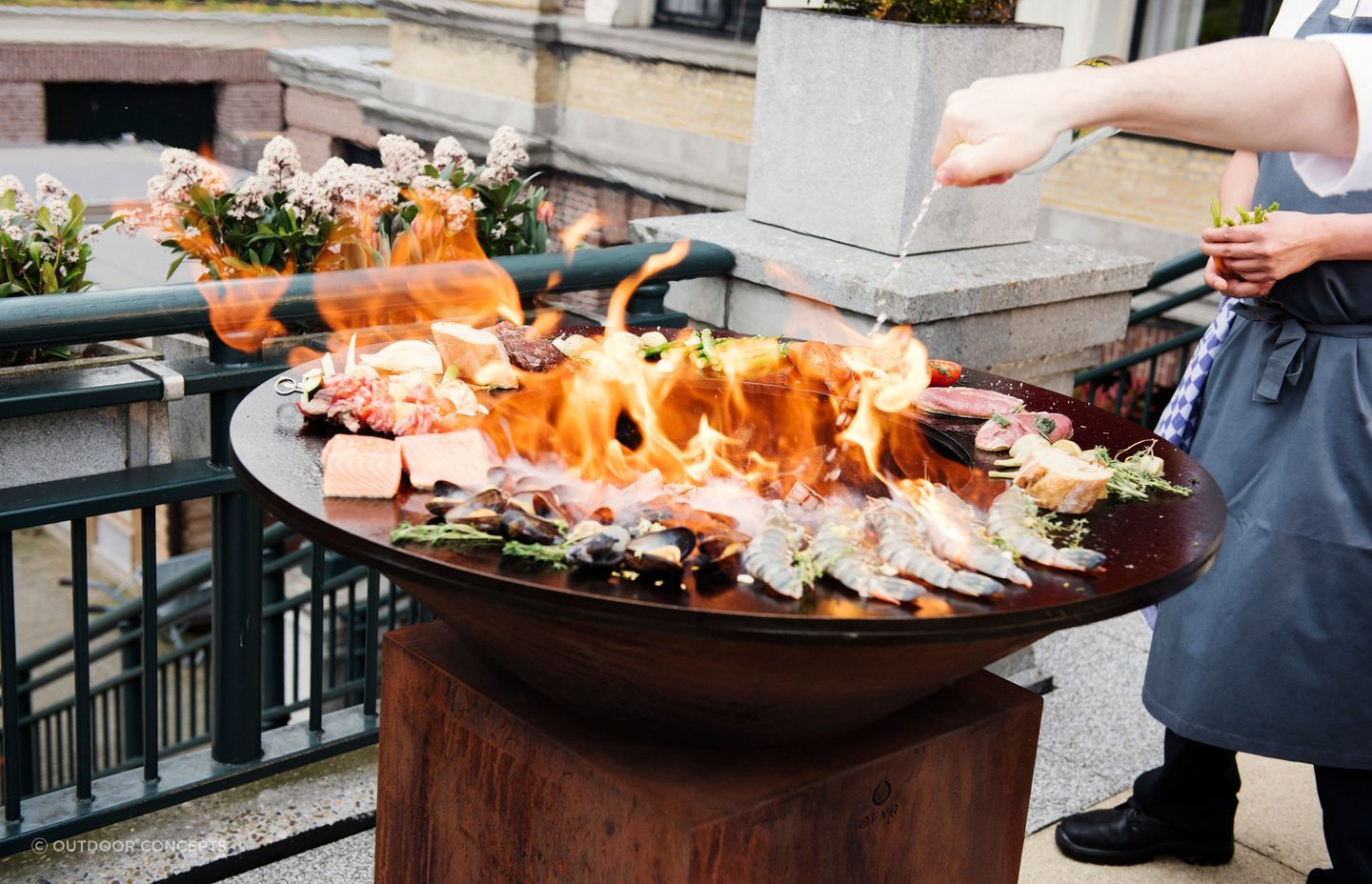 A fire pit with a hotplate or grill is a real showstopper, as you can see with the 100/100 by OFYR Outdoor Fire and Grill.