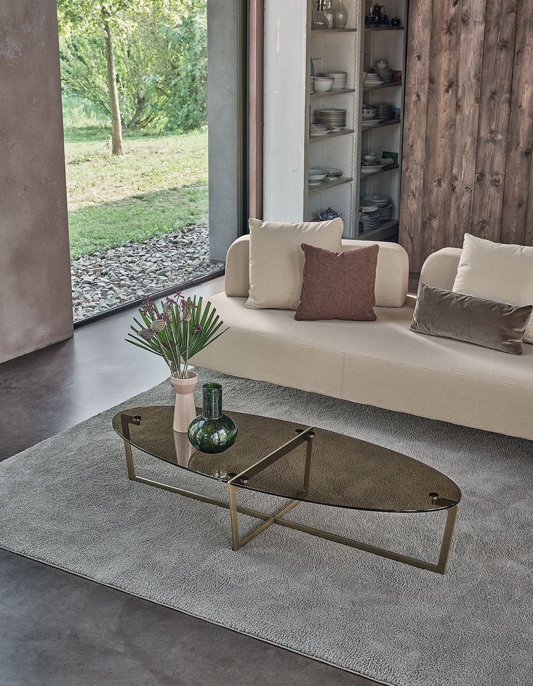 It's easy to compliment an oval coffee table with a vase and a stylish rug.