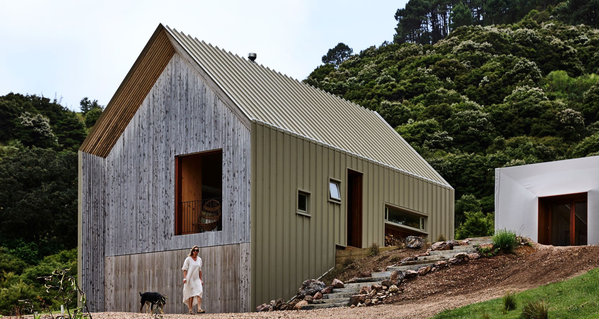 Awaawaroa House features a unique design by Cheshire Architects, comprising three buildings around a central courtyard, utilising COLORSTEEL® Lichen.