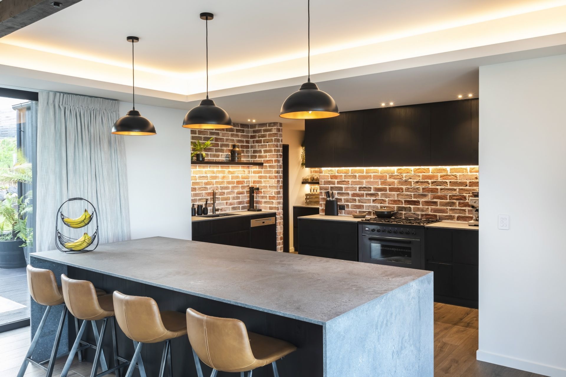Recessed lighting highlights interesting design features in this modern kitchen built by DJ Hewitt Builders.
