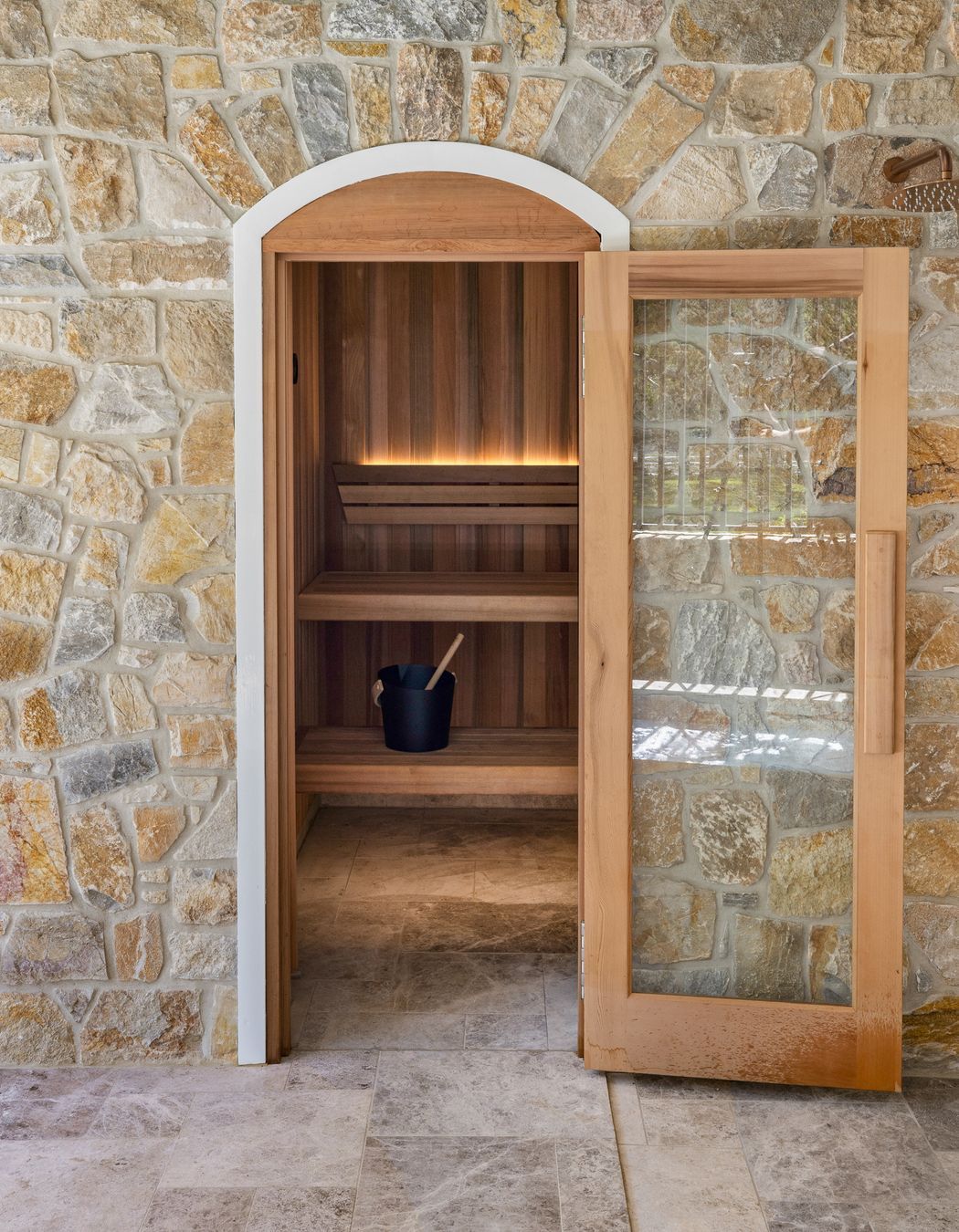 On both floors and walls, natural stone can add character, texture and depth to a space.