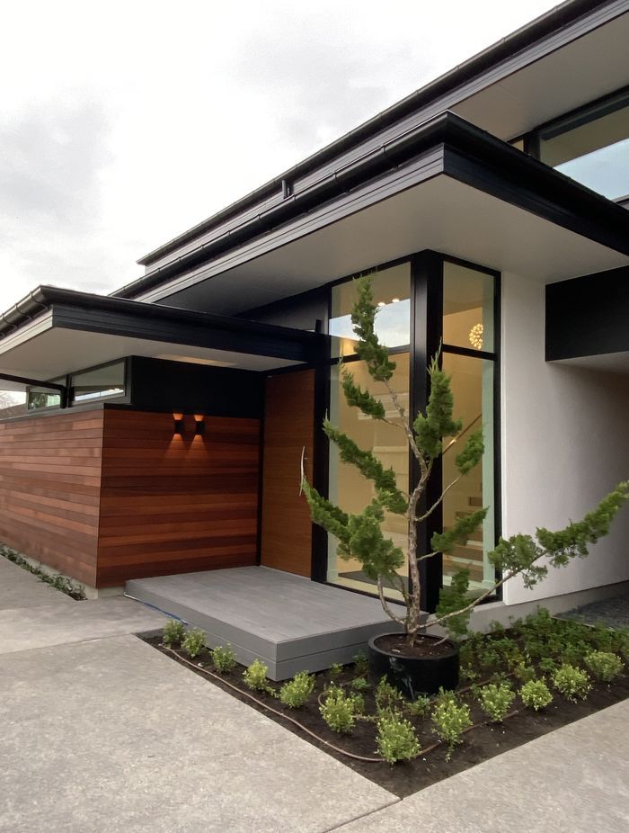Built by DJ Hewitt Builders, this Christchurch home features RockCote Integra, horizontal cedar and schist on the chimney, and Colorsteel flashing to match the joinery.