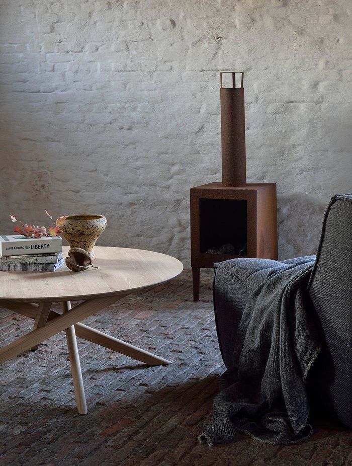 This round coffee table features a smooth surface and cross-legged design. Featured product: Mikado Round Coffee Table.