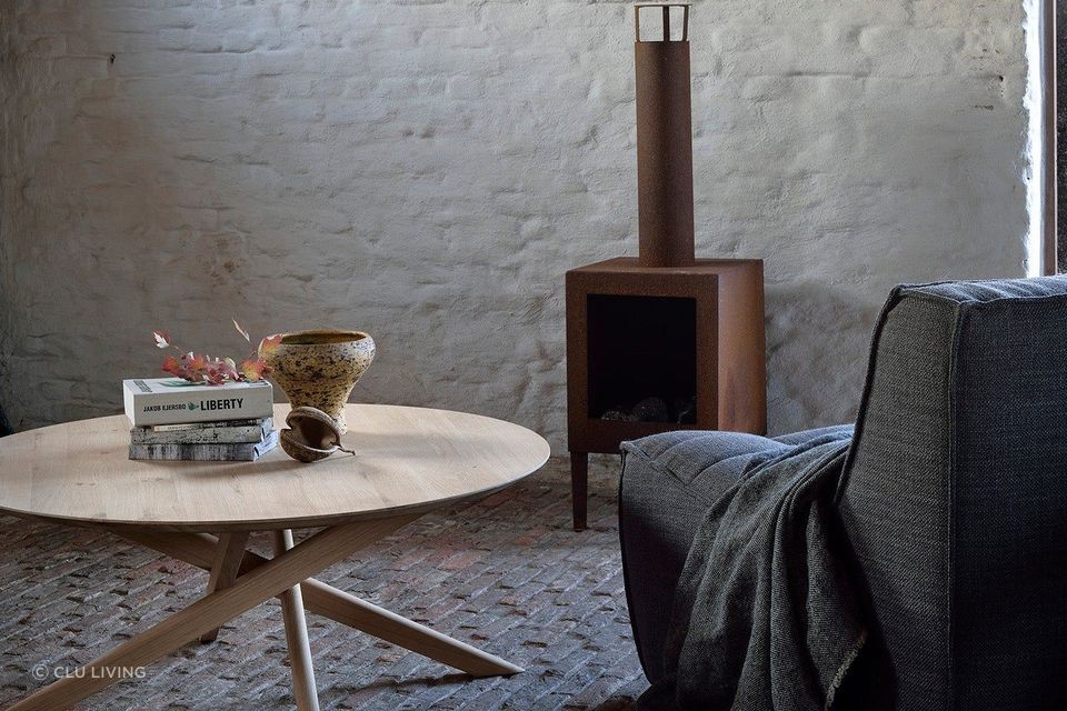 This round coffee table features a smooth surface and cross-legged design. Featured product: Mikado Round Coffee Table.