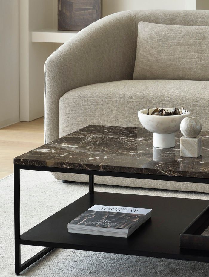 A polished marble coffee table stands as a statement piece in a living room.