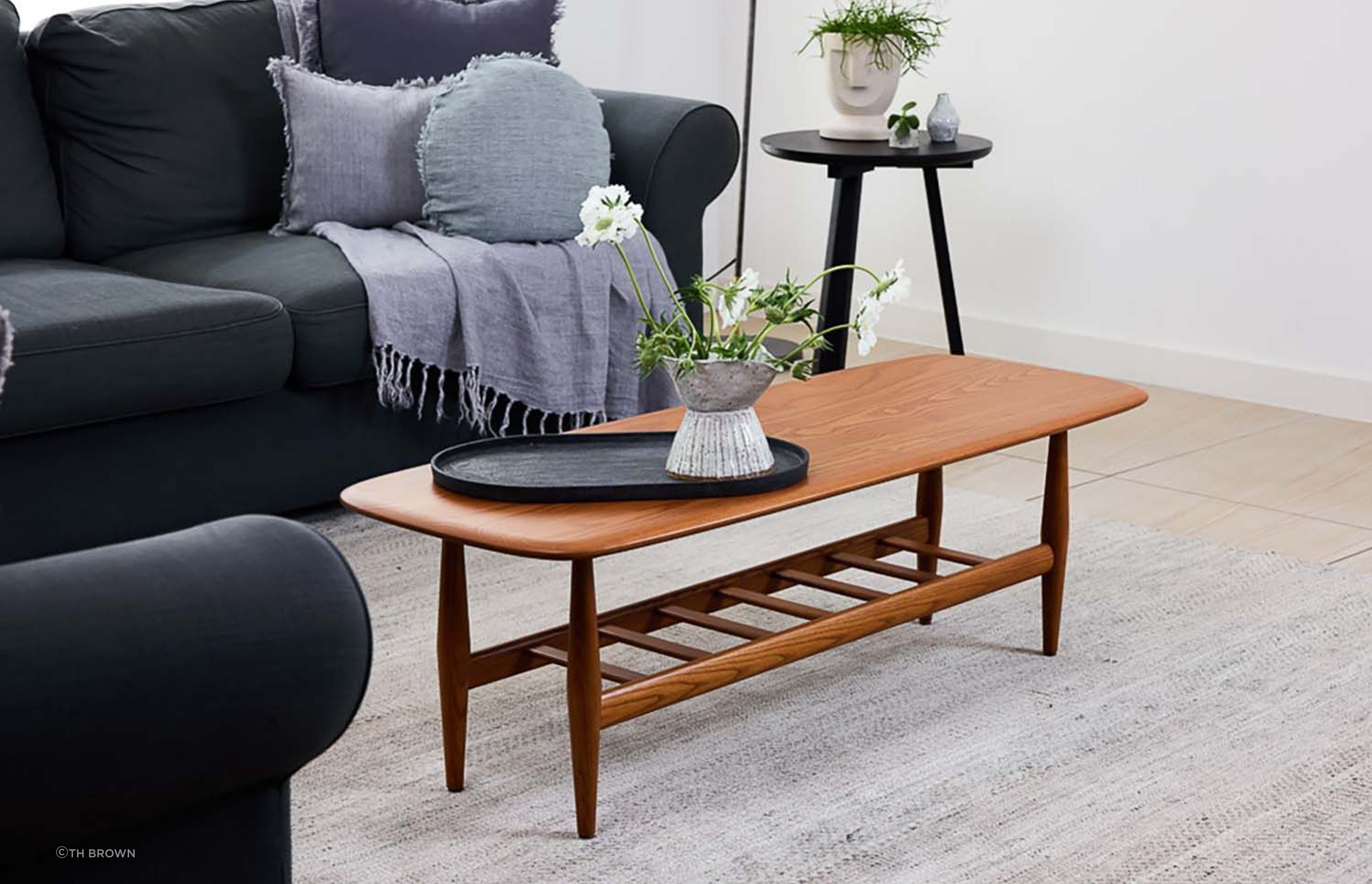 This solid dark ash coffee table boasts a convenient, functional magazine rack. Featured product: Frisco Coffee Table.