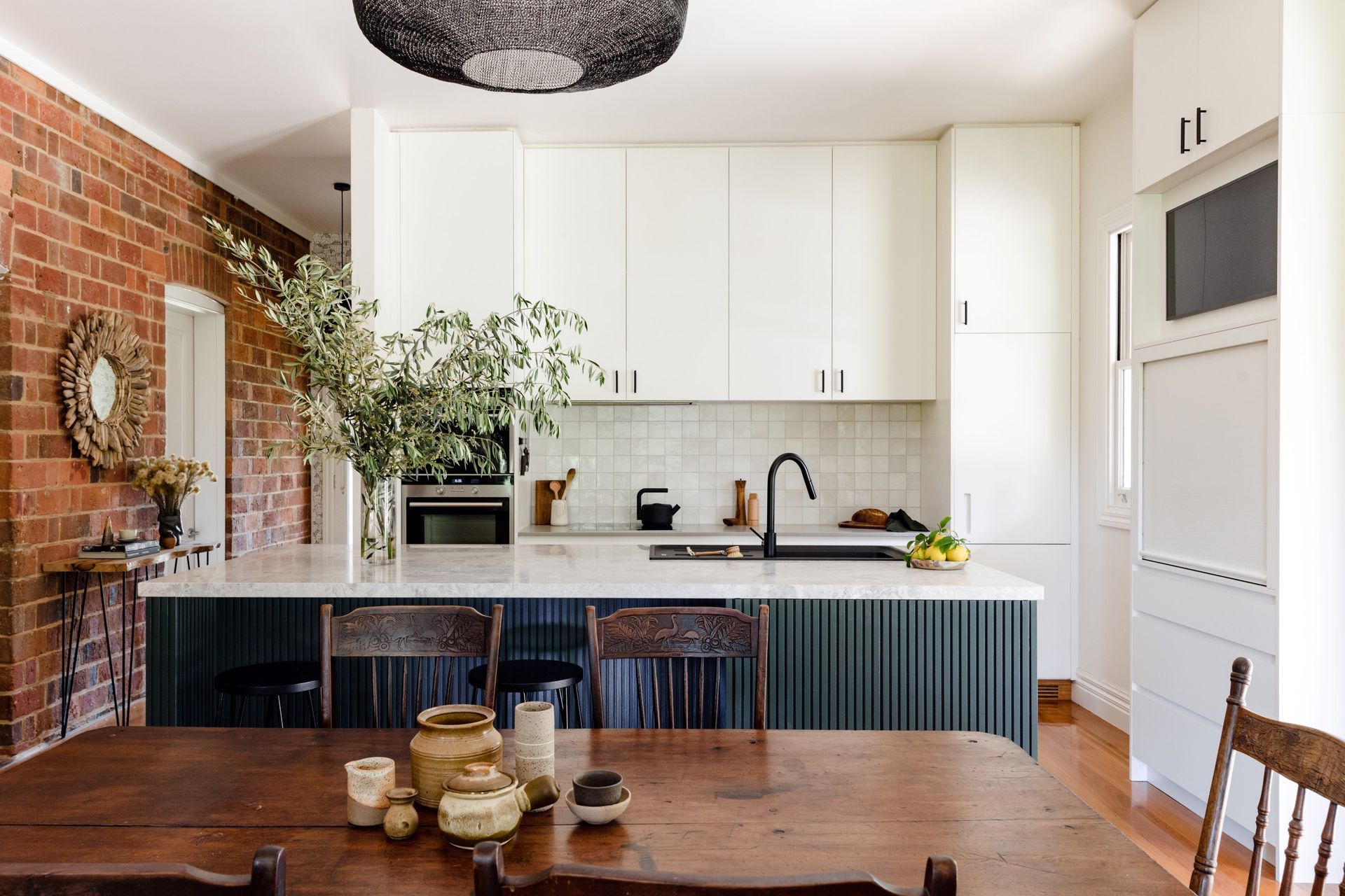 The flat white cabinets chosen for this kitchen in Beechworth were the perfect complement for the rustic space.