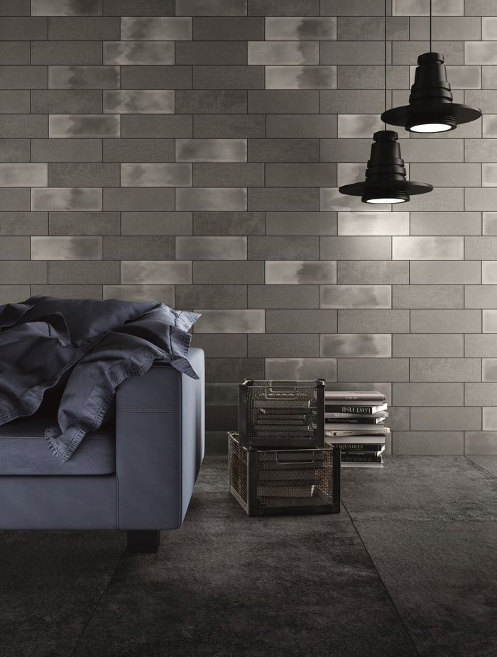 The grey Living Camp Wall tiles work well with this dark charcoal and light, creating a sophisticated industrial-looking interior.