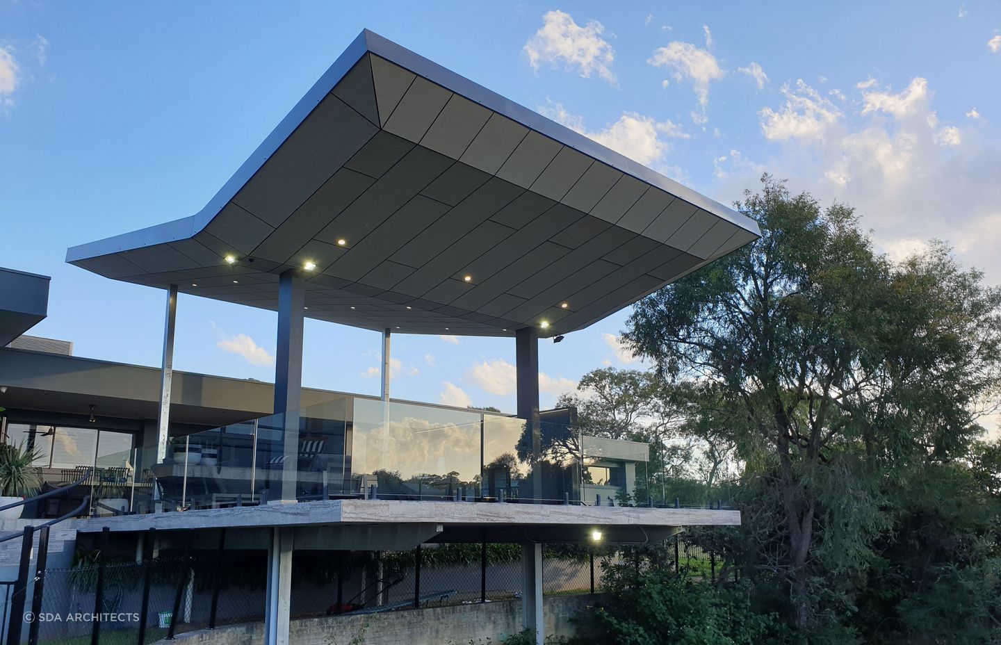 A butterfly roof, marked by its distinctive inverted V shape allows natural light to penetrate an area. Featured project: Annandale Patio
