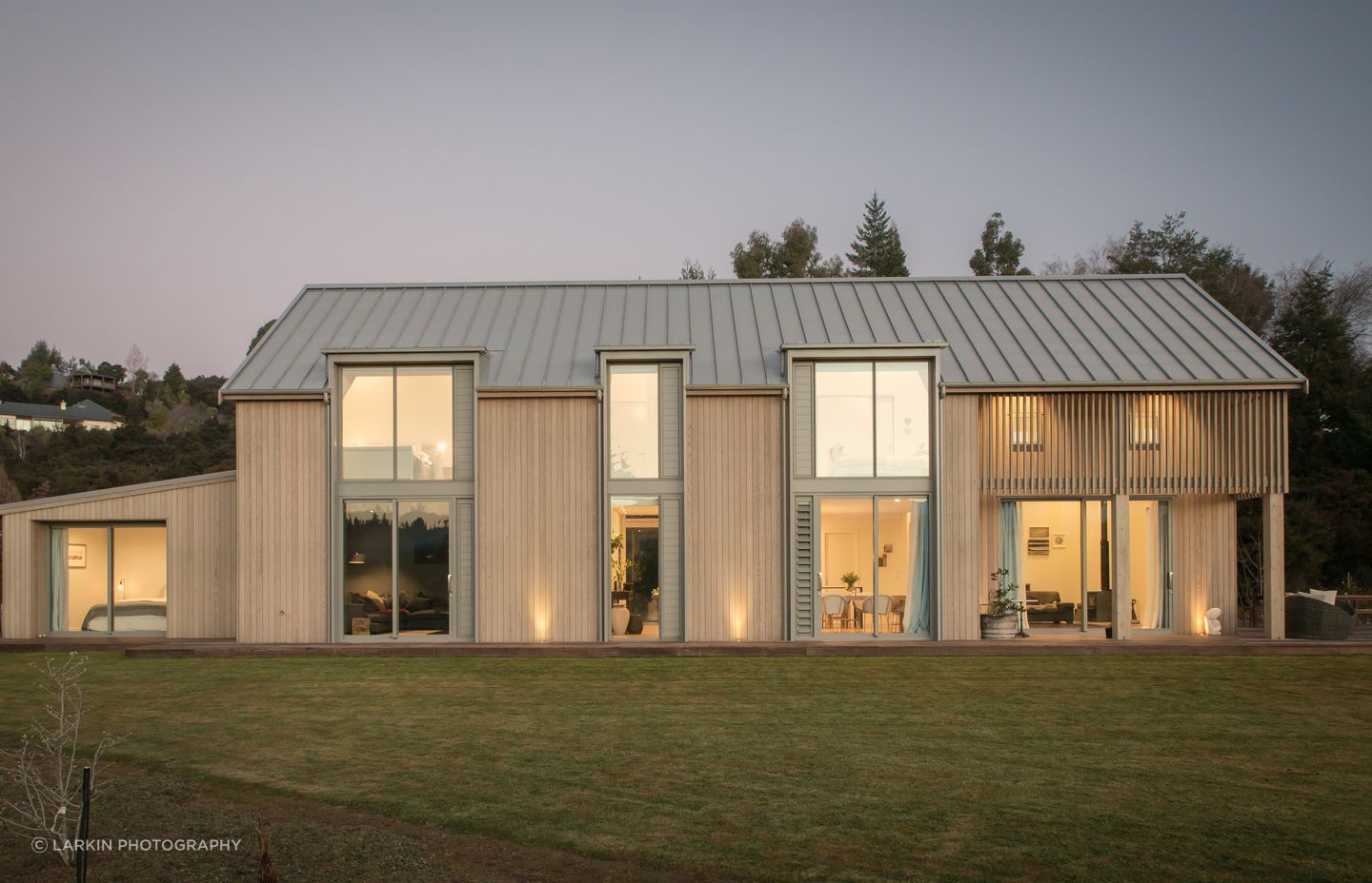 A contemporary barn-style home in Wanaka, designed by Condon Scott Architects, featuring a COLORSTEEL roof in a tray profile.