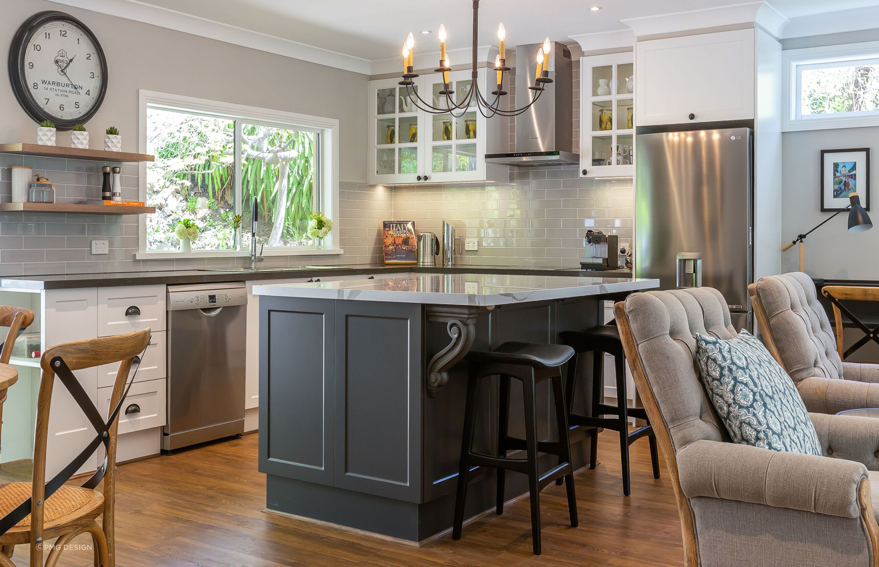 A Hamptons Style kitchen with a graceful iron chandelier.