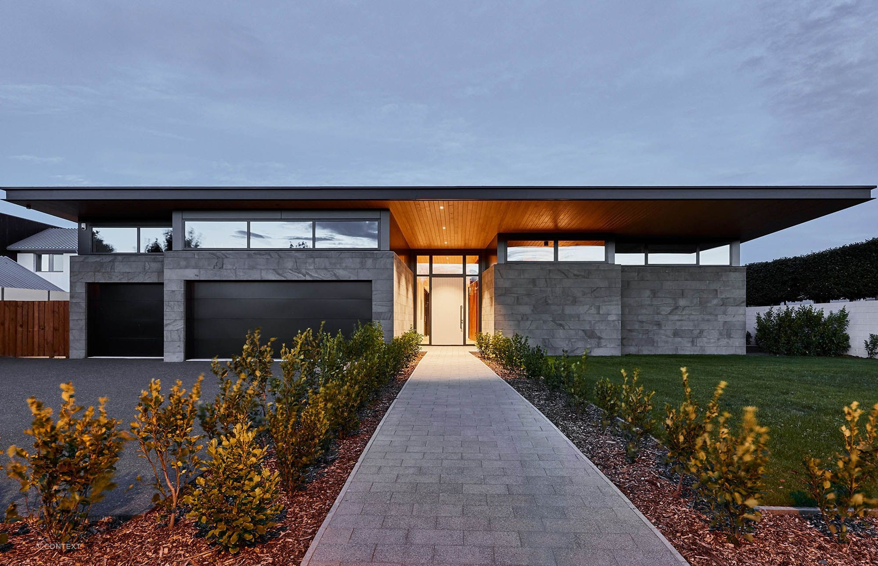 Doubling up on Timaru Bluestone with cladding and paving at the sublime Clearwater House in Christchurch.