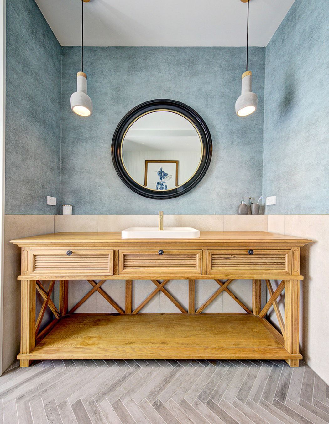 Interior design excellence shines through with a coastal feature wall, infusing the bathroom with the tranquil vibes of the shore.