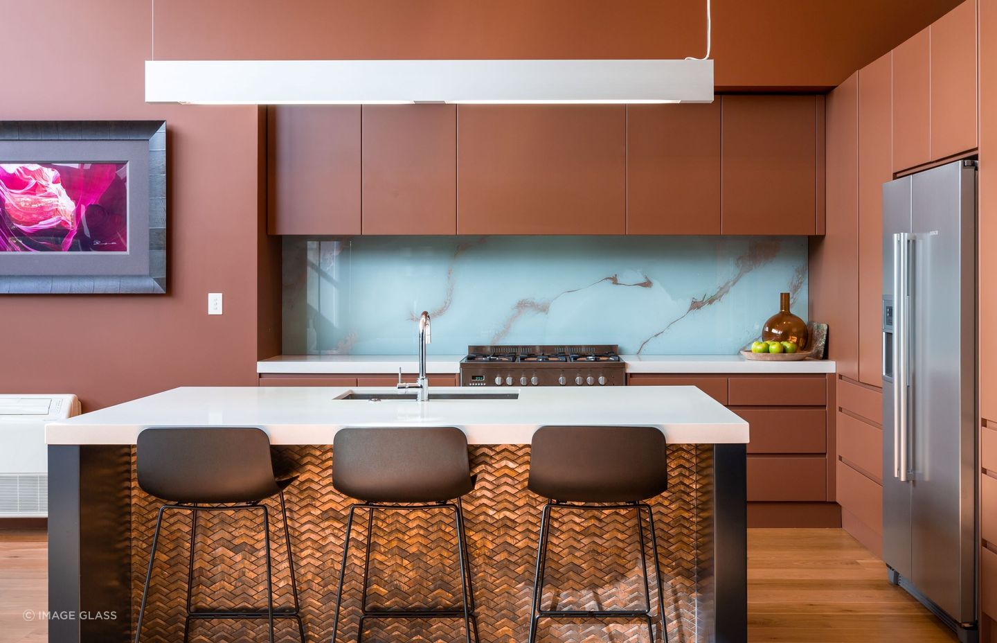 A great execution of colour featuring a blue splashback with copper marbling.