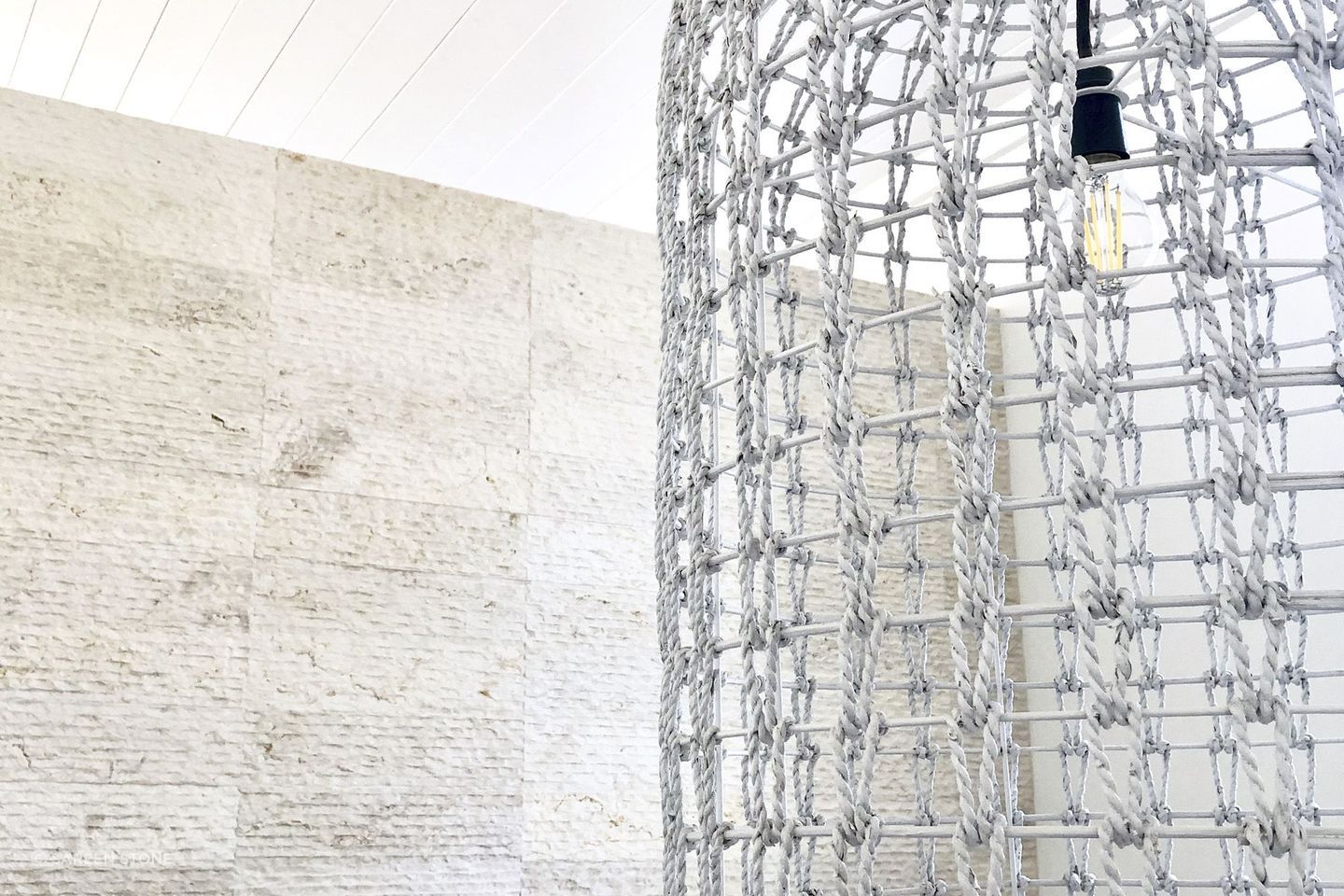 Cream wall cladding in action: modern aesthetic meets warm, soft-textured Crema Alpenia Limestone for an effortlessly contemporary look. Featured product: Cascade Cream Wall Cladding.