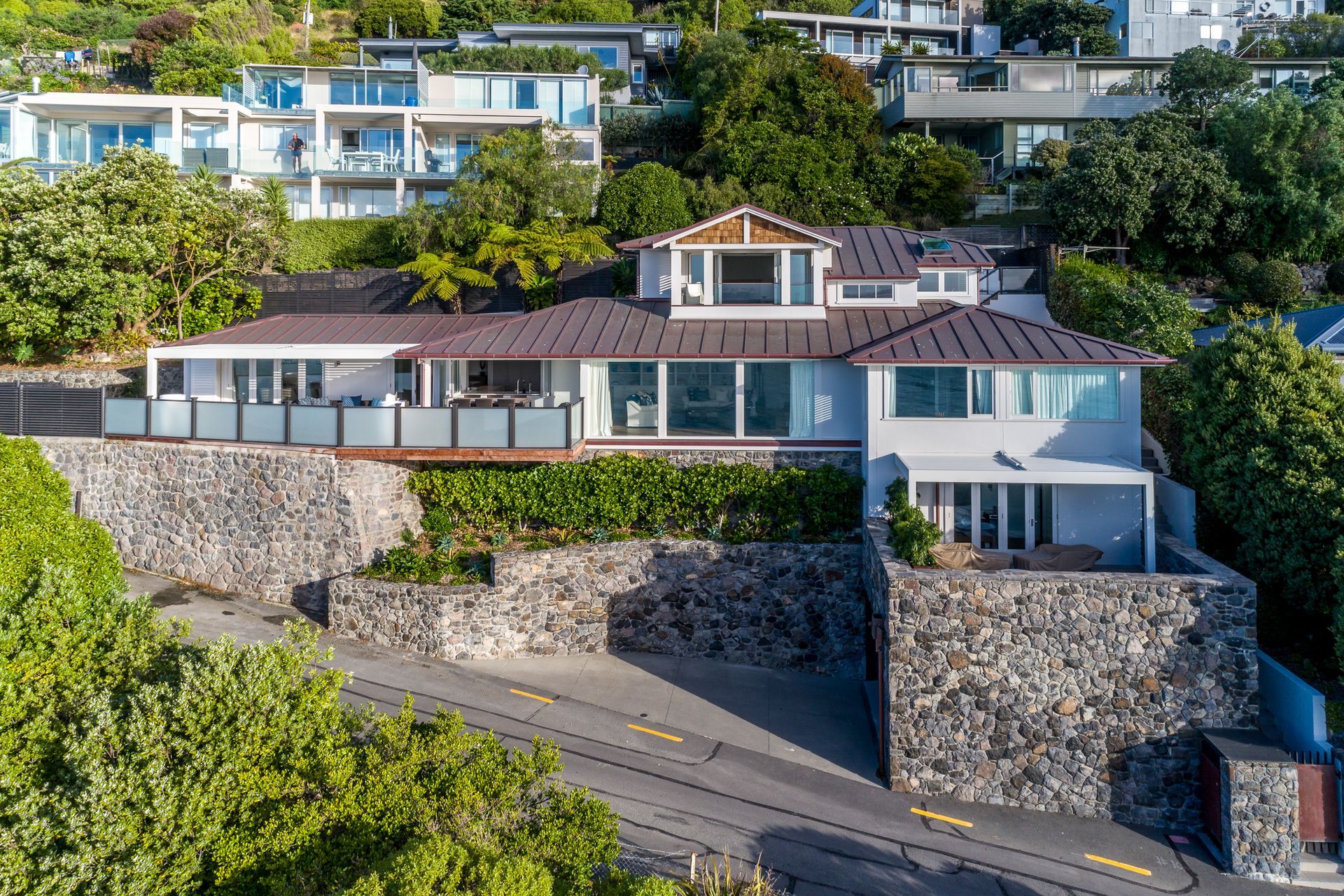Stone walls  make a feature out of the extensive retaining required for this hillside build.