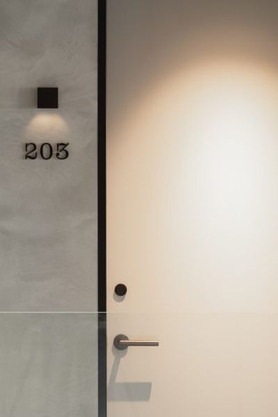 Strategically placed down lights highlight room doors at EBB Hotel.