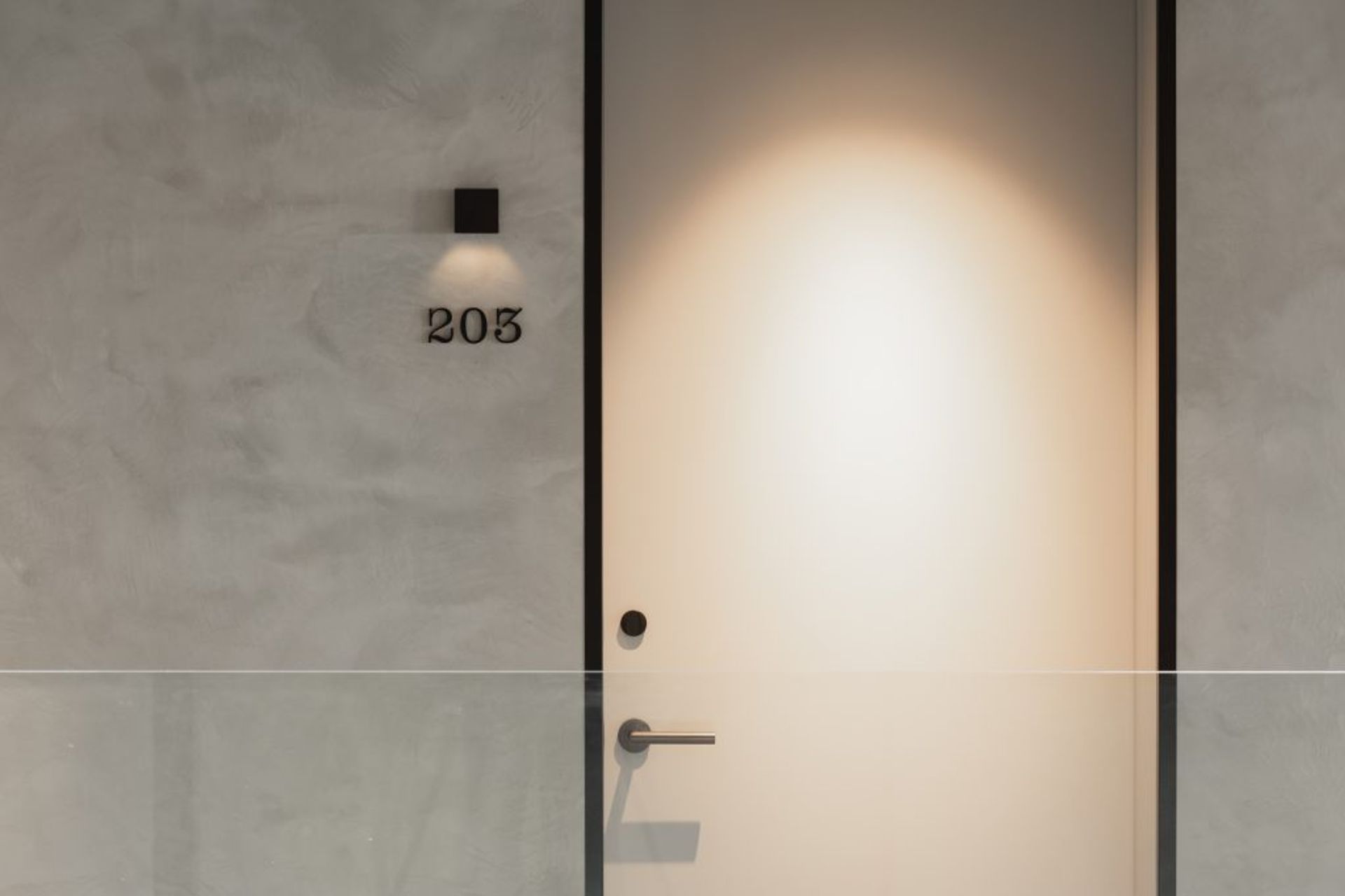 Strategically placed down lights highlight room doors at EBB Hotel.