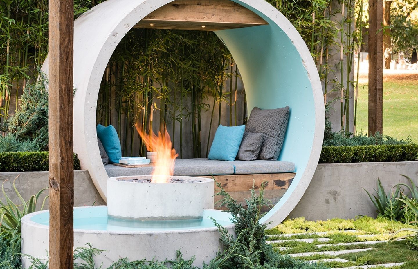 Incorporating your fire pit into a water feature, stylishly done here with the EcoSmart AB8 Ethanol Fireplace, can result in a stunning focal point for your backyard.
