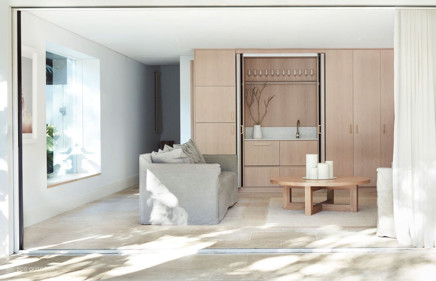 Tiles are a great way of creating indoor-outdoor flow, seen here with the Eco Outdoor Sandstone Outdoor Pavers.